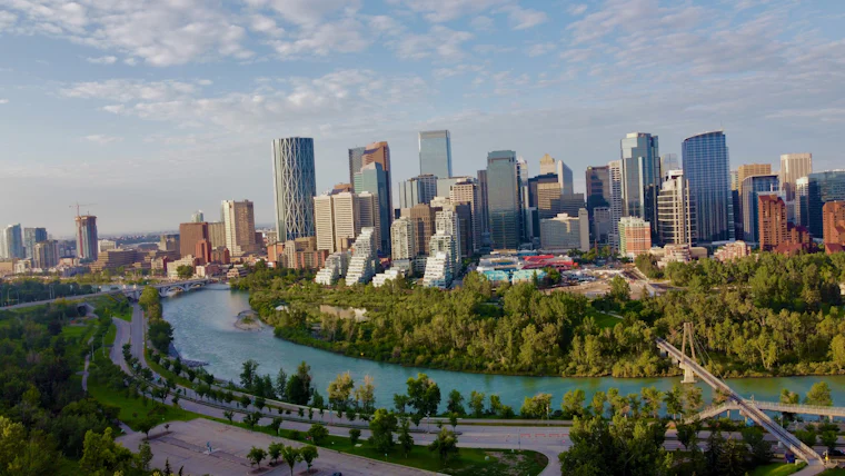 The Bow River curving through parkland with the downtown Calgary skyline behind