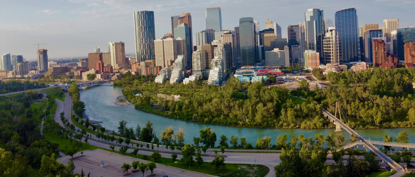 The Bow River curving through parkland with the downtown Calgary skyline behind
