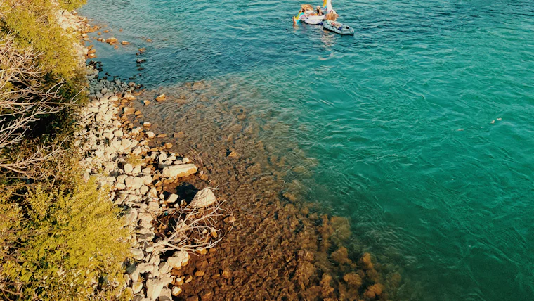Paddlers on the Bow River between autumn trees in Calgary