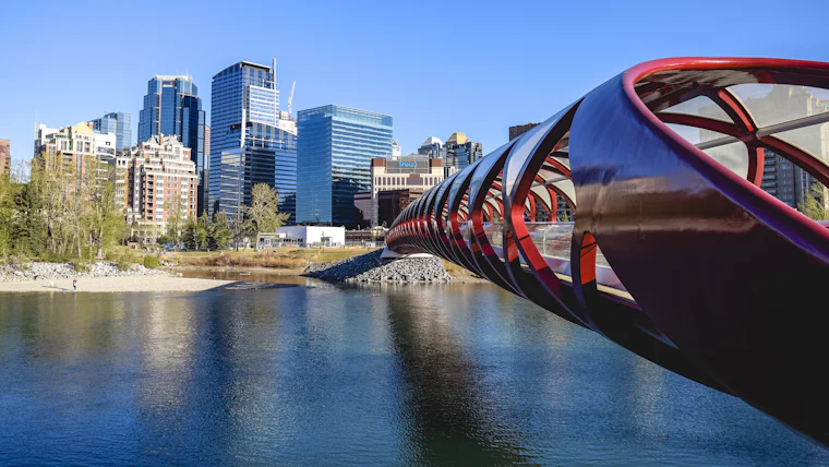 The Peace Bridge over the Bow River with the downtown Calgary towers behind