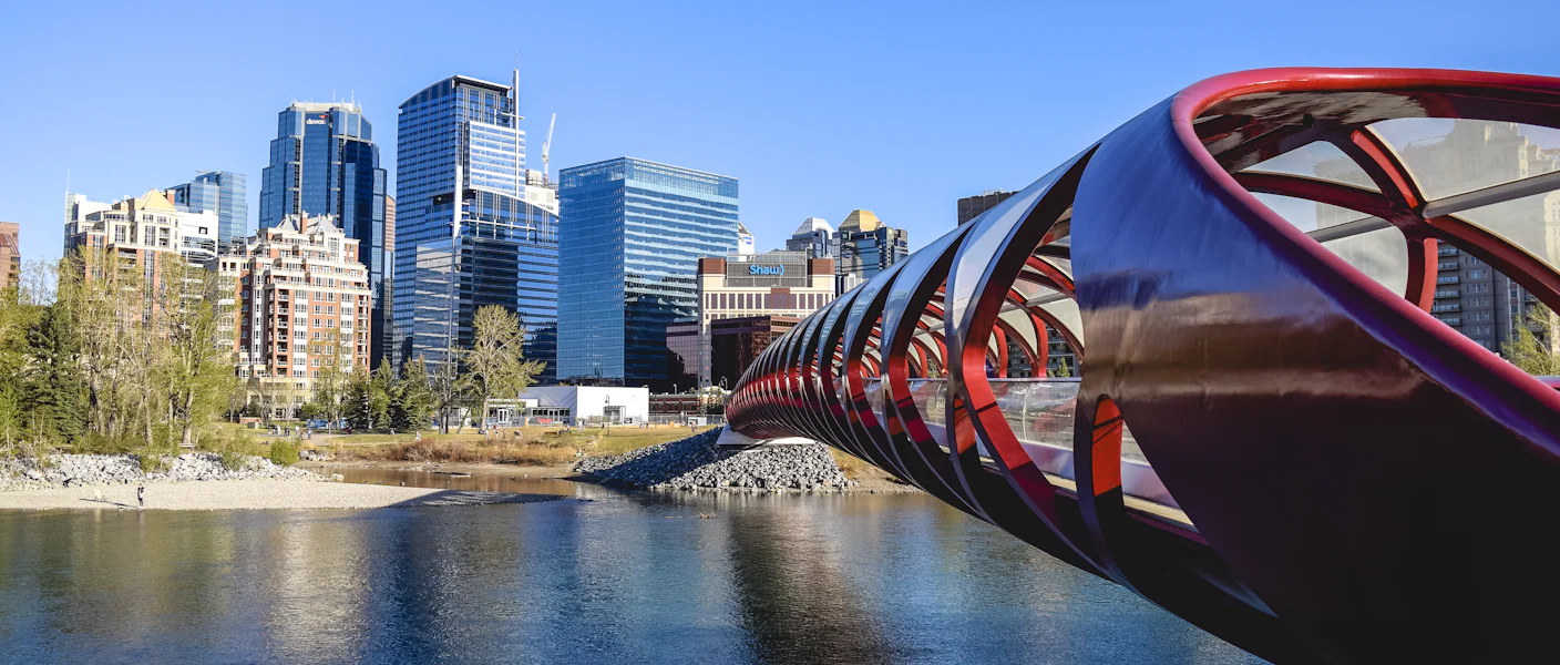 The Peace Bridge over the Bow River with the downtown Calgary towers behind
