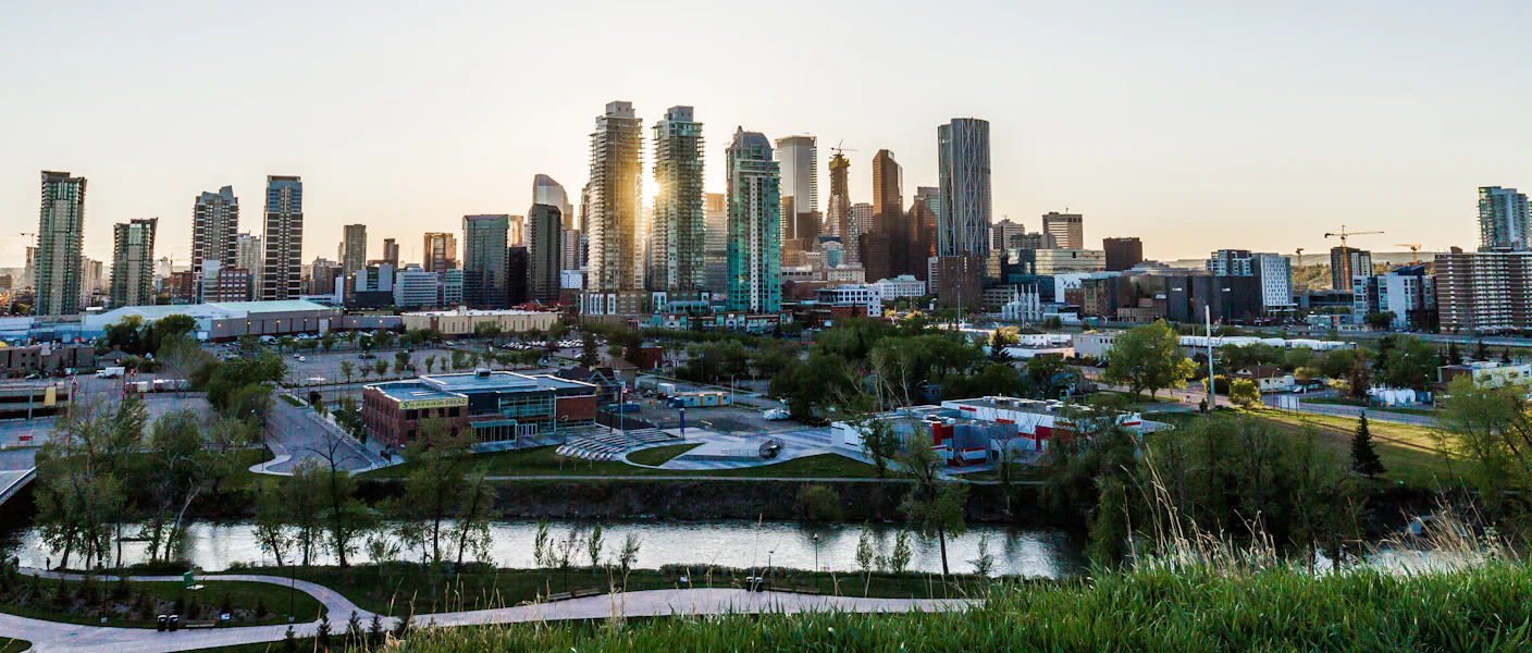 The Calgary skyline at dusk seen across the river valley