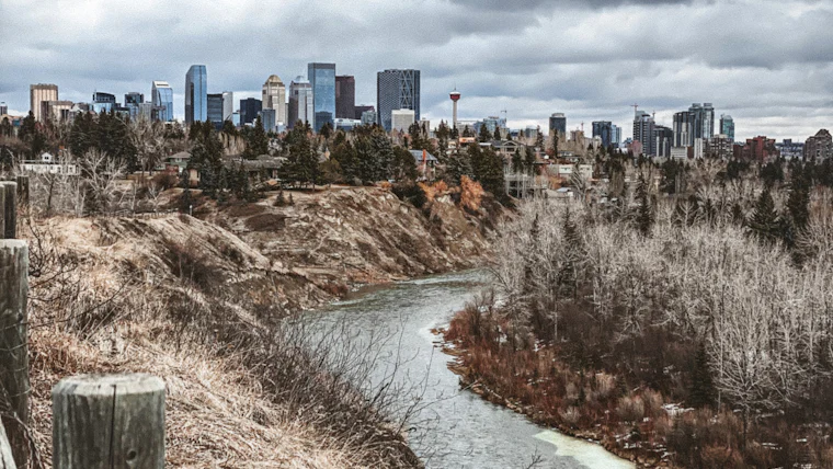 The frozen Bow River valley with downtown Calgary behind in winter