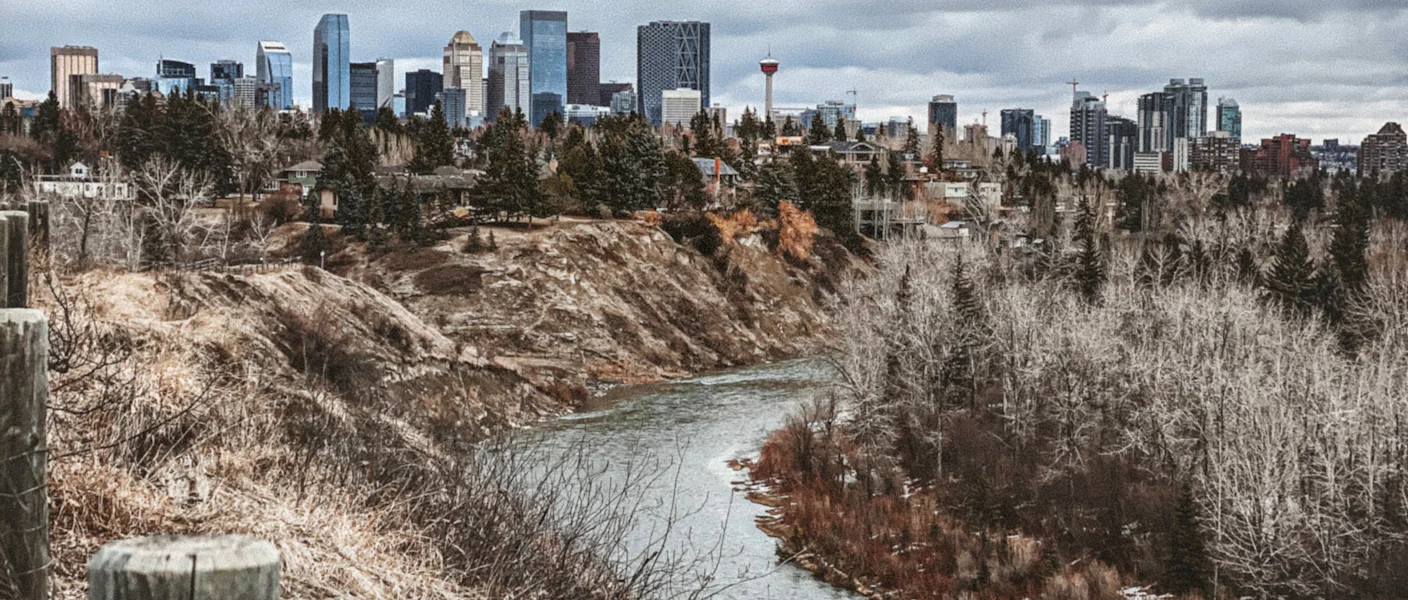 The frozen Bow River valley with downtown Calgary behind in winter